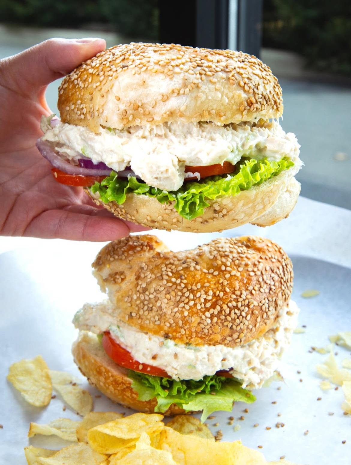Chicken salad bagel sandwiches with chips