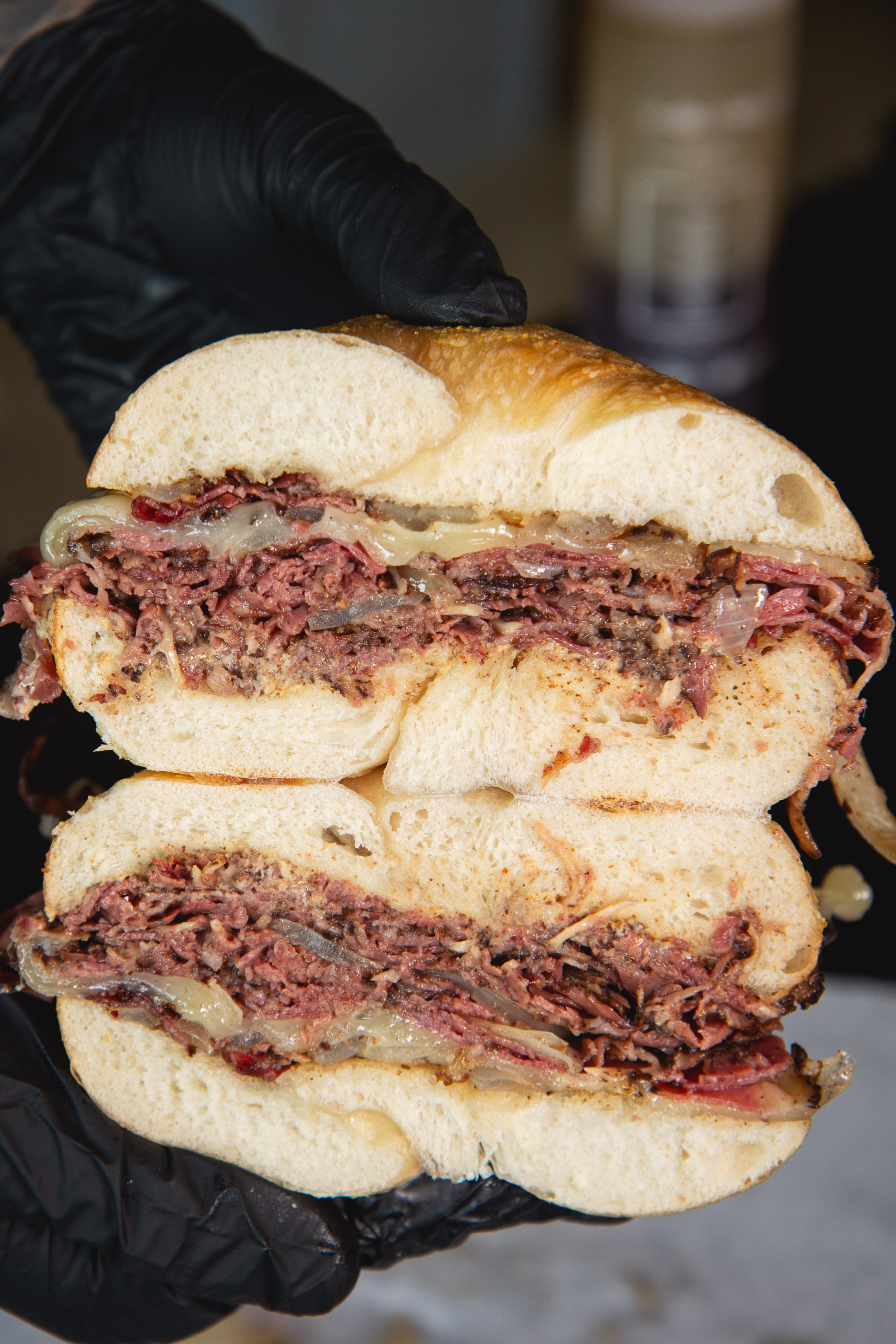 Hot pastrami sandwich on a bagel with melted cheese