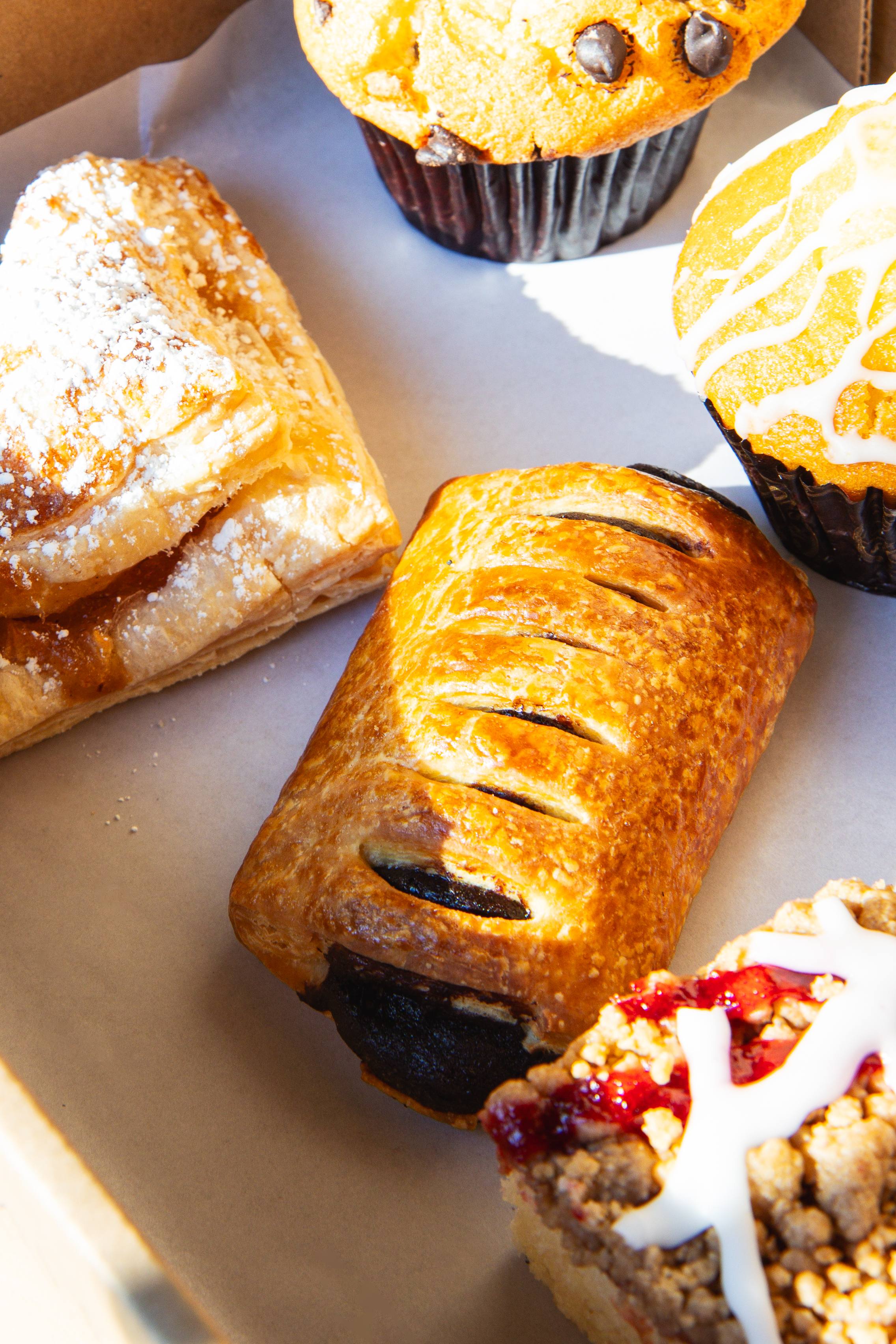 Assorted pastries including croissants, muffins, and danish